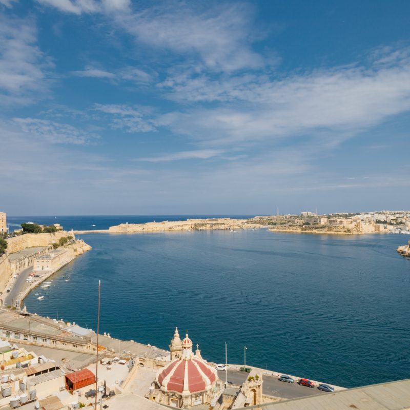 Grand Harbour of Malta with the ancient walls of Valletta on a sunny day.